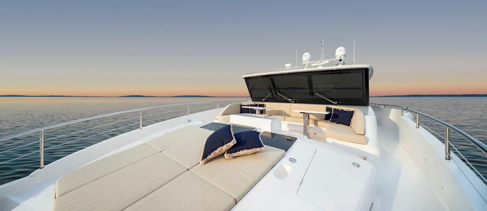 FD87 Aqua Life Foredeck Sunpad and curved seating with tables.