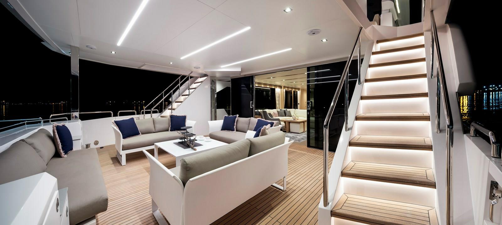 FD87 Aqua Life Aft Deck with four sofas, coffee table and staircases.