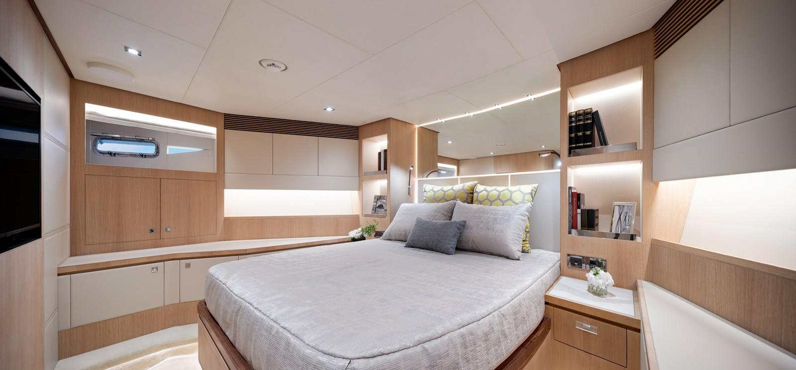 FD87 Aqua Life Bow VIP stateroom with queen bed, nightstands, bookshelves and TV.