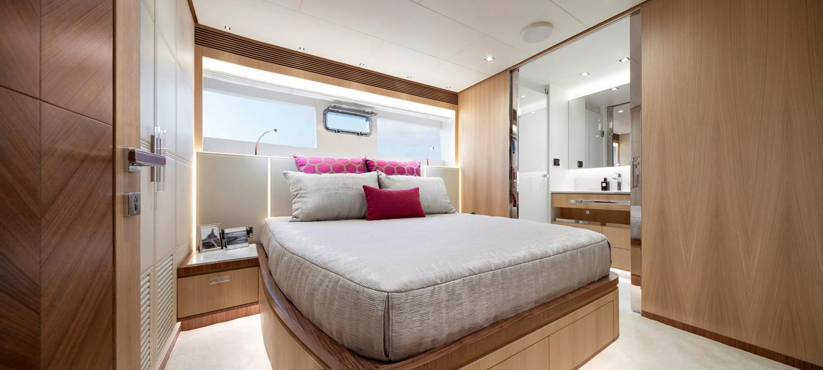 FD87 Aqua Life VIP Guest stateroom with queen bed, nightstand and head.